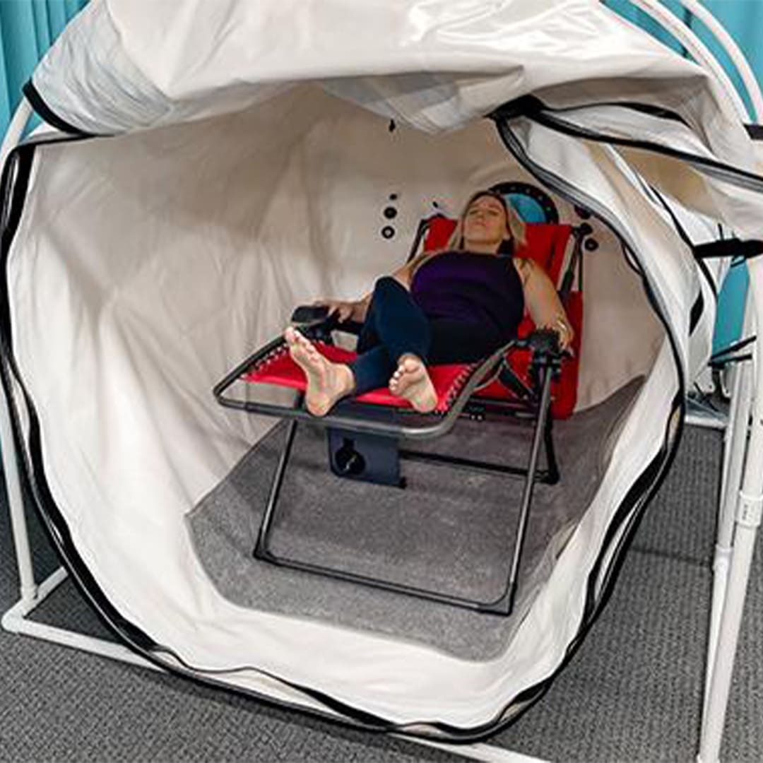 woman on a lounge chair in Hyperbaric Oxygen Chamber